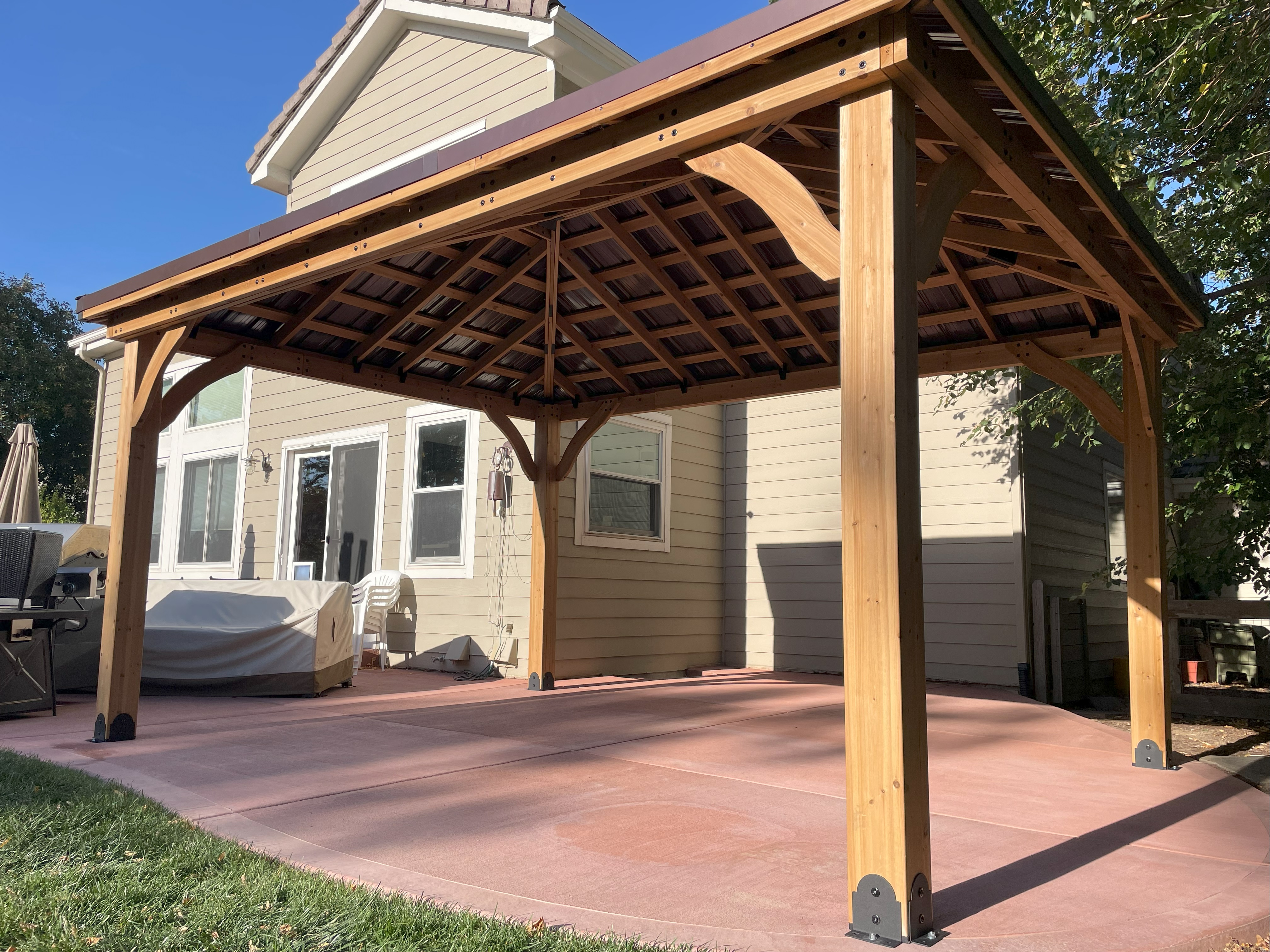 Pergola installation with cedar finish and open lattice design
