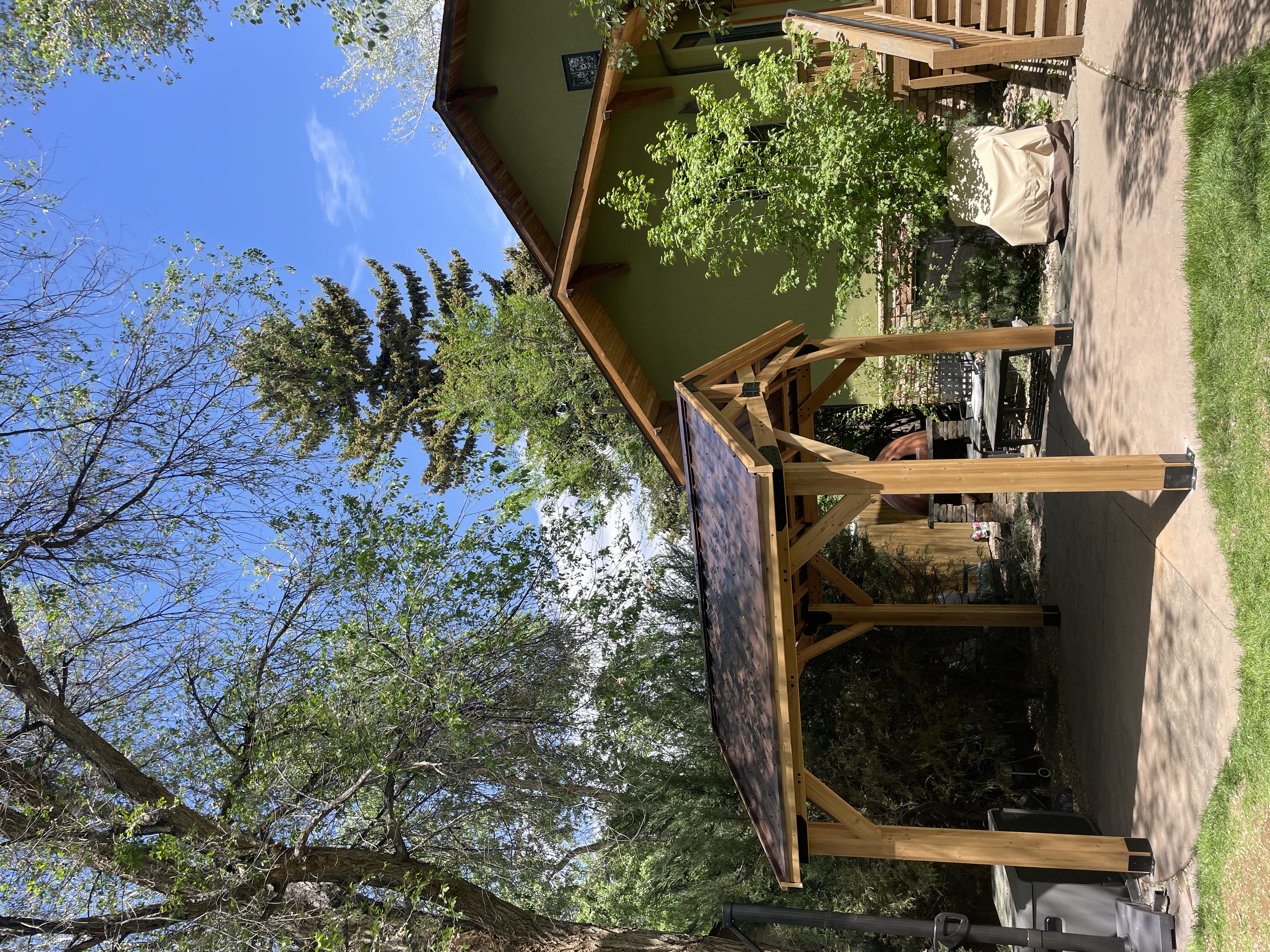 Pergola with stone fireplace in mountain setting